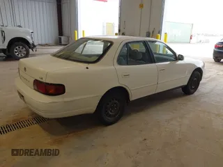 1996 Toyota Camry DX with VIN JT2BG12K3T0401659, listed as a IAAI auction lot 41874795 with 169,406 mi miles. Bid and sale history available at carsss.com. Image 4.