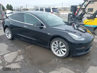 2020 Tesla Model 3 Standard Range Plus with VIN 5YJ3E1EA8LF645569, listed as a IAAI auction lot 41697452 with 84,590 mi miles. Bid and sale history available at carsss.com. Image 1.