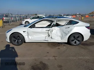 2023 Tesla Model 3 with VIN 5YJ3E1EA2PF582331, listed as a IAAI auction lot 41043858 with 33,601 mi miles and . Bid and sale history available at DreamBid. Image 14.