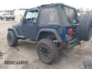 2003 Jeep Wrangler X with VIN 1J4FA39S23P300447, listed as a IAAI auction lot 41791733 with 165,576 mi miles. Bid and sale history available at carsss.com. Image 3.