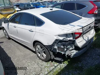 2016 Ford Fusion Titanium Hybrid with VIN 3FA6P0RU1GR259947, listed as a IAAI auction lot 41695377 with 97,605 mi miles. Bid and sale history available at carsss.com. Image 3.