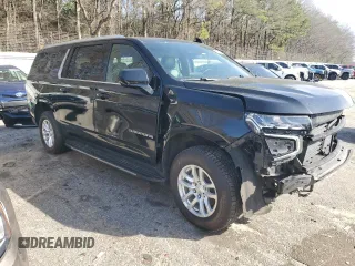 2023 Chevrolet Suburban LS with VIN 1GNSCBKD8PR163178, listed as a Copart auction lot 47844175 with 104,369 mi miles and Salvage Title. Bid and sale history available at DreamBid. Image 4.
