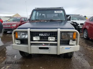 1991 Isuzu Trooper z VIN JACCH58E3M7900325, wystawiony jako Copart lot #79525294 z przebiegiem 146 593 mil mil oraz Czysty tytuł • Clean title. Historia ofert i sprzedaży dostępna na DreamBid. Obrazek 5.