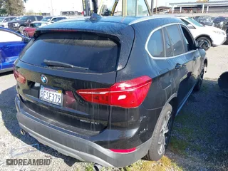 2018 BMW X1 sDrive28i with VIN WBXHU7C39J5L07129, listed as a IAAI auction lot 41472014 with 56,486 mi miles. Bid and sale history available at carsss.com. Image 4.
