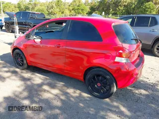 2009 Toyota Yaris with VIN JTDJT903695234623, listed as a IAAI auction lot 42027852 with 146,000 mi miles. Bid and sale history available at carsss.com. Image 3.