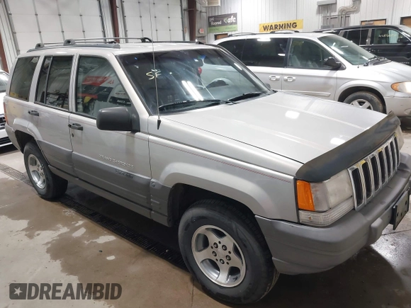 1996 Jeep Grand Cherokee Laredo z VIN 1J4GZ58S5TC293897, wystawiony jako IAAI lot #42435233 z przebiegiem 167 432 mil mil oraz . Historia ofert i sprzedaży dostępna na DreamBid. Obrazek 1.