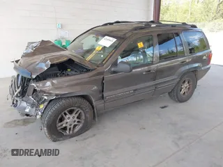 1999 Jeep Grand Cherokee Limited z VIN 1J4GW68N0XC512229, wystawiony jako IAAI lot #42189815 z przebiegiem 230 028 mil mil oraz . Historia ofert i sprzedaży dostępna na DreamBid. Obrazek 18.