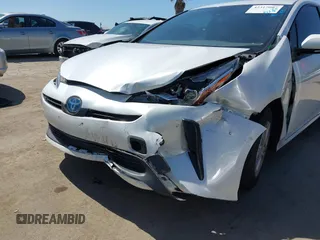 2021 Toyota Prius L Eco with VIN JTDKAMFU8M3135142, listed as a IAAI auction lot 42317007 with 77,353 mi miles and . Bid and sale history available at DreamBid. Image 6.