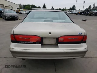1995 Ford Thunderbird LX with VIN 1FALP62W45H169199, listed as a Copart auction lot 65458964 with 111,726 mi miles and Salvage Title. Bid and sale history available at DreamBid. Image 6.