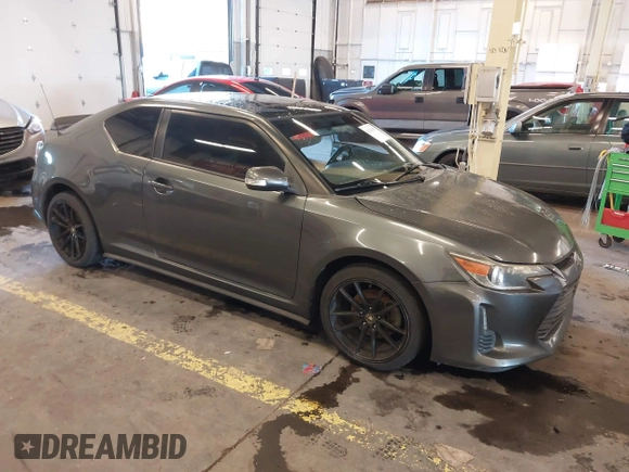 2014 Scion tC with VIN JTKJF5C77E3069906, listed as a IAAI auction lot 41243445 with 128,791 mi miles. Bid and sale history available at carsss.com. Image 1.