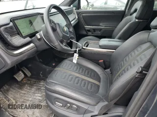 2022 Rivian R1S Launch Edition with VIN 7PDSGABL3NN000739, listed as a Copart auction lot 88127995 with 12,143 mi miles and Salvage Title. Bid and sale history available at DreamBid. Image 7.