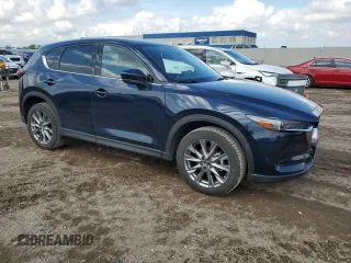 2021 Mazda CX-5 Grand Touring with VIN JM3KFBDM0M0500561, listed as a Copart auction lot 58214665 with 49,543 mi miles and Salvage title. Bid and sale history available at DreamBid. Image 4.