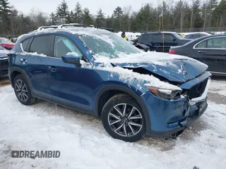 2018 Mazda CX-5 Touring z VIN JM3KFBCM4J0316995, wystawiony jako IAAI lot #41538464 z przebiegiem 65 894 mil mil oraz . Historia ofert i sprzedaży dostępna na DreamBid. Obrazek 1.