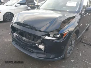 2018 Mazda CX-5 Touring z VIN JM3KFACM3J1435089, wystawiony jako IAAI lot #41130041 z przebiegiem 80 446 mil mil oraz . Historia ofert i sprzedaży dostępna na DreamBid. Obrazek 6.