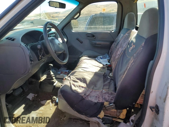 1999 Ford F-150 z VIN 1FTRF18W1XKA87801, wystawiony jako Copart lot #79094454 z przebiegiem Nie podano mil oraz Szkoda całkowita • Salvage title. Historia ofert i sprzedaży dostępna na DreamBid. Obrazek 7.