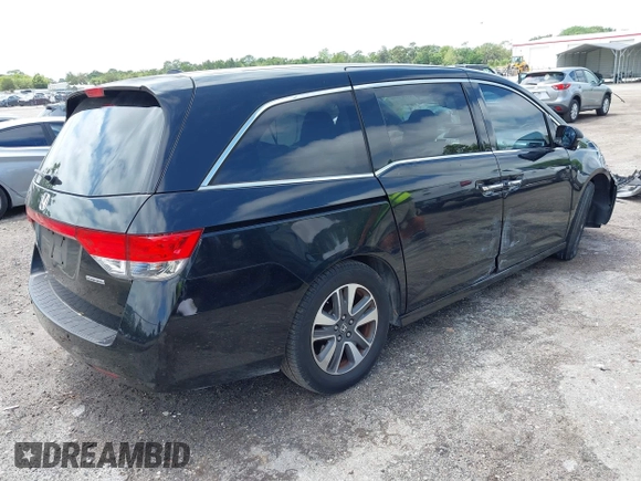 2014 Honda Odyssey Touring with VIN 5FNRL5H94EB057499, listed as a IAAI auction lot 41983956 with 158,573 mi miles and . Bid and sale history available at DreamBid. Image 4.