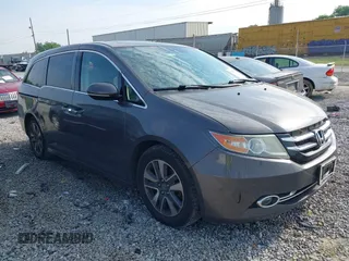 2014 Honda Odyssey Touring with VIN 5FNRL5H99EB111685, listed as a IAAI auction lot 42141227 with 183,484 mi miles and . Bid and sale history available at DreamBid. Image 1.