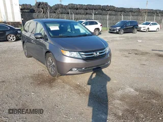 2015 Honda Odyssey Touring Elite with VIN 5FNRL5H94FB071825, listed as a IAAI auction lot 42804197 with 128,401 mi miles and . Bid and sale history available at DreamBid. Image 1.