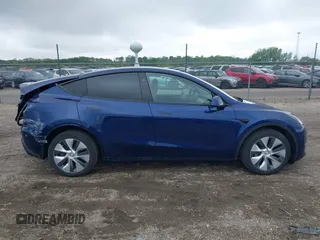 2023 Tesla Model Y Long Range z VIN 7SAYGDEE0PF840787, wystawiony jako IAAI lot #42172489 z przebiegiem 16 314 mil mil oraz . Historia ofert i sprzedaży dostępna na DreamBid. Obrazek 14.