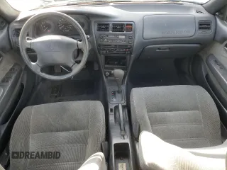 1994 Toyota Corolla Deluxe with VIN JT2AE09B4R0067104, listed as a Copart auction lot 83565064 with 207,923 mi miles and Salvage title. Bid and sale history available at DreamBid. Image 8.