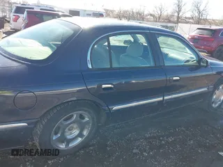 1999 Lincoln Continental with VIN 1LNHM97V8XY700644, listed as a IAAI auction lot 41641082 with 142,527 mi miles. Bid and sale history available at carsss.com. Image 13.