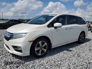 2018 Honda Odyssey Touring z VIN 5FNRL6H80JB061086, wystawiony jako Copart lot #66669875 z przebiegiem 119 359 mil mil oraz Czysty tytuł • Clean title. Historia ofert i sprzedaży dostępna na DreamBid. Obrazek 1.