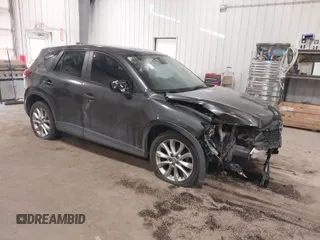 2015 Mazda CX-5 Grand Touring with VIN JM3KE4DYXF0467606, listed as a IAAI auction lot 41345790 with 107,915 mi miles. Bid and sale history available at carsss.com. Image 1.