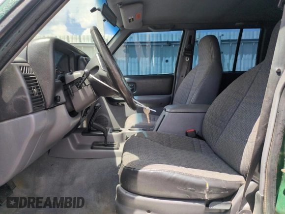 1998 Jeep Cherokee Sport with VIN 1J4FJ68SXWL210381, listed as a Copart auction lot 58398995 with 211,870 mi miles and Salvage title. Bid and sale history available at DreamBid. Image 7.