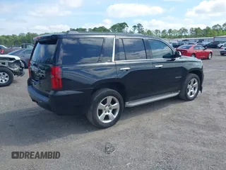2015 Chevrolet Tahoe LT with VIN 1GNSCBKC1FR615817, listed as a IAAI auction lot 41760474 with 242,148 mi miles and . Bid and sale history available at DreamBid. Image 4.