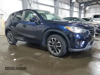 2016 Mazda CX-5 Grand Touring with VIN JM3KE4DY0G0826687, listed as a Copart auction lot 50886975 with 130,493 mi miles and Salvage Title. Bid and sale history available at carsss.com. Image 4.