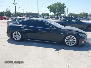 2014 Tesla Model S P85D with VIN 5YJSA1H25EFP65571, listed as a IAAI auction lot 42185442 with 115,990 mi miles and . Bid and sale history available at DreamBid. Image 12.