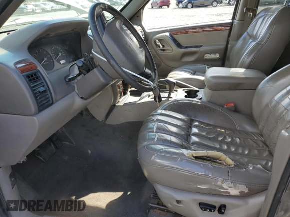 1999 Jeep Grand Cherokee Limited with VIN 1J4GW68S2XC677334, listed as a Copart auction lot 74152054 with 242,220 mi miles and Salvage Title. Bid and sale history available at carsss.com. Image 7.