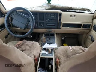 1995 Jeep Cherokee Sport with VIN 1J4FJ68S4SL618773, listed as a Copart auction lot 74126954 with 318,519 mi miles and Salvage title. Bid and sale history available at DreamBid. Image 8.