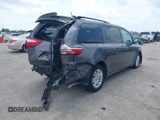 2015 Toyota Sienna XLE with VIN 5TDYK3DCXFS688971, listed as a IAAI auction lot 42127912 with 143,024 mi miles. Bid and sale history available at carsss.com. Image 4.