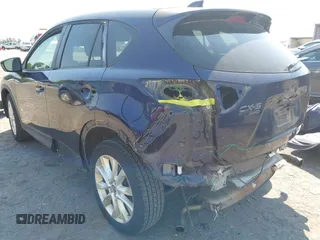2014 Mazda CX-5 Grand Touring with VIN JM3KE4DYXE0342720, listed as a IAAI auction lot 42026388 with 114,072 mi miles and . Bid and sale history available at carsss.com. Image 3.