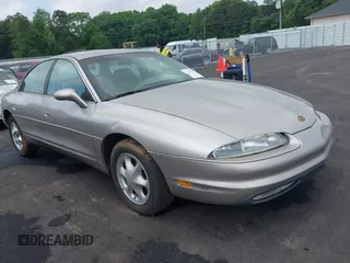 1997 Oldsmobile Aurora z VIN 1G3GR62CXV4121200, wystawiony jako IAAI lot #42277003 z przebiegiem 198 048 mil mil oraz . Historia ofert i sprzedaży dostępna na DreamBid. Obrazek 1.