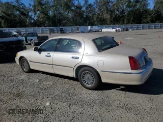 2001 Lincoln Town Car Cartier z VIN 1LNHM83W31Y671814, wystawiony jako Copart lot #77169664 z przebiegiem Nie podano mil oraz Szkoda całkowita • Salvage title. Historia ofert i sprzedaży dostępna na DreamBid. Obrazek 2.