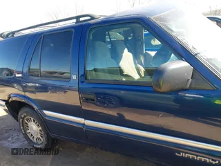 1999 GMC Jimmy SLE with VIN 1GKDT13W3X2553792, listed as a IAAI auction lot 41876489 with 266,884 mi miles. Bid and sale history available at carsss.com. Image 14.