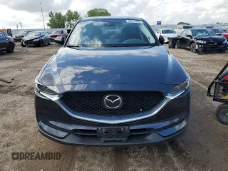 2021 Mazda CX-5 Grand Touring with VIN JM3KFBDM0M0500561, listed as a Copart auction lot 58214665 with 49,543 mi miles and Salvage title. Bid and sale history available at DreamBid. Image 5.