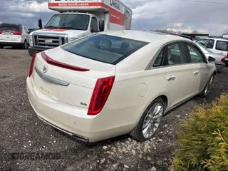 2013 Cadillac XTS Platinum z VIN 2G61V5S33D9173441, wystawiony jako IAAI lot #41902672 z przebiegiem 103 044 mil mil oraz . Historia ofert i sprzedaży dostępna na DreamBid. Obrazek 4.