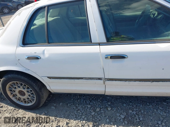 2004 Mercury Grand Marquis GS z VIN 2MEFM74W74X654151, wystawiony jako IAAI lot #42185493 z przebiegiem 203 017 mil mil oraz . Historia ofert i sprzedaży dostępna na DreamBid. Obrazek 11.