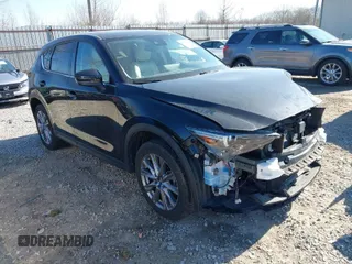 2021 Mazda CX-5 Grand Touring with VIN JM3KFBDM0M0468081, listed as a IAAI auction lot 41894411 with 54,664 mi miles. Bid and sale history available at carsss.com. Image 1.