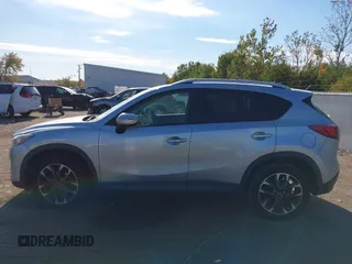 2016 Mazda CX-5 Grand Touring z VIN JM3KE2DY3G0712249, wystawiony jako IAAI lot #37910910 z przebiegiem 262 058 mil mil oraz . Historia ofert i sprzedaży dostępna na DreamBid. Obrazek 14.