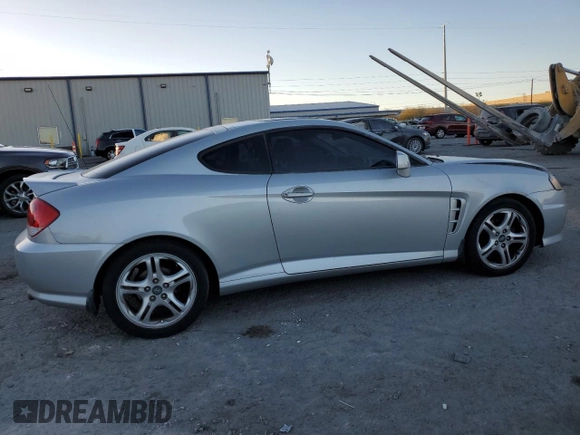 2005 Hyundai Tiburon GT z VIN KMHHN65F05U171038, wystawiony jako Copart lot #87765735 z przebiegiem 113 129 mil mil oraz Szkoda całkowita • Salvage title. Historia ofert i sprzedaży dostępna na DreamBid. Obrazek 3.