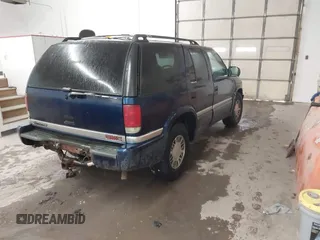 1999 GMC Jimmy SLE with VIN 1GKDT13W8X2534672, listed as a IAAI auction lot 41562434 with 240,145 mi miles. Bid and sale history available at carsss.com. Image 4.