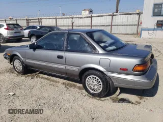 1990 Toyota Corolla z VIN JT2AE96J0L3382052, wystawiony jako Copart lot #57894754 z przebiegiem 90 550 mil mil oraz Czysty tytuł • Clean title. Historia ofert i sprzedaży dostępna na DreamBid. Obrazek 2.