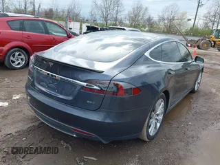 2015 Tesla Model S 85D with VIN 5YJSA1E21FF116775, listed as a IAAI auction lot 41876772 with 128,805 mi miles. Bid and sale history available at carsss.com. Image 4.