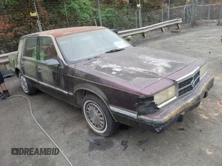 1992 Dodge Dynasty LE z VIN 1B3XC56R0ND750136, wystawiony jako IAAI lot #41955511 z przebiegiem 144 248 mil mil oraz . Historia ofert i sprzedaży dostępna na DreamBid. Obrazek 1.