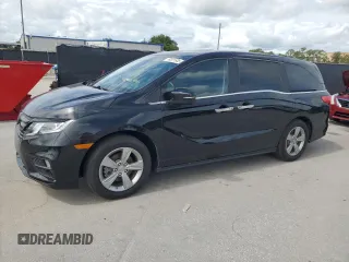 2018 Honda Odyssey EX-L z VIN 5FNRL6H7XJB031245, wystawiony jako Copart lot #59331635 z przebiegiem 74 901 mil mil oraz Czysty tytuł • Clean title. Historia ofert i sprzedaży dostępna na DreamBid. Obrazek 1.