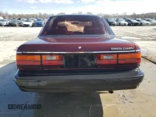 1989 Toyota Camry DLX z VIN 4T1SV21E3KU053153, wystawiony jako Copart lot #49917485 z przebiegiem 79 028 mil mil oraz Szkoda całkowita • Salvage title. Historia ofert i sprzedaży dostępna na DreamBid. Obrazek 6.